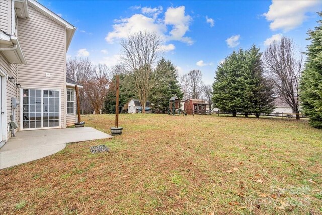 130 Valley Glen Dr, Troutman, NC 28166 - view of grassy yard featuring a playground and a patio