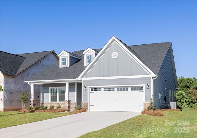 219 Tillery Ln Unit 755, Mount Gilead, NC 27306 - view of front facade with an attached garage, driveway, a front lawn, a shingled roof, and board and batten siding