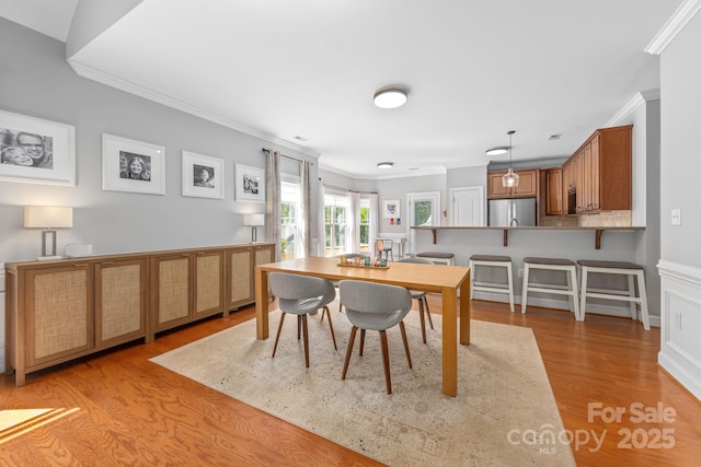 516 King St, Waxhaw, NC 28173 - dining room featuring crown molding and light wood-style flooring