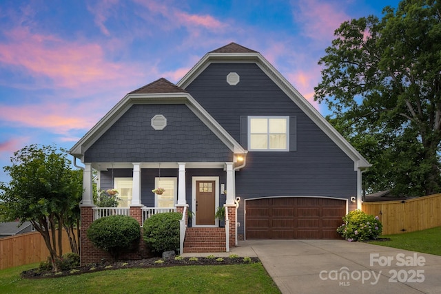 516 King St, Waxhaw, NC 28173 - view of front of home featuring a garage, covered porch, driveway, and brick siding