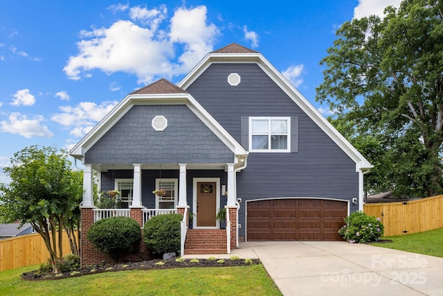 516 King St, Waxhaw, NC 28173 - view of front facade featuring a porch, a garage, concrete driveway, and brick siding