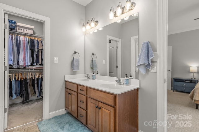 516 King St, Waxhaw, NC 28173 - full bathroom featuring double vanity, baseboards, a walk in closet, ornamental molding, and ensuite bath