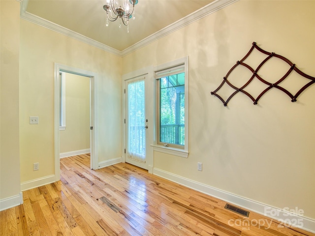 20A Lila Ln, Clyde, NC 28721 - foyer entrance featuring crown molding, a chandelier, hardwood / wood-style floors, and baseboards