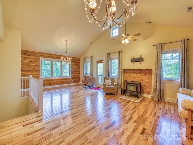 20A Lila Ln, Clyde, NC 28721 - living area featuring a chandelier, plenty of natural light, high vaulted ceiling, and a wood stove