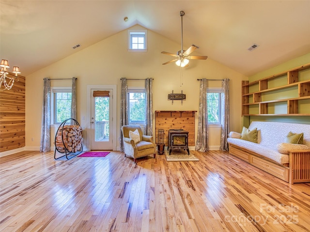 20A Lila Ln, Clyde, NC 28721 - living area featuring a wood stove, light wood-type flooring, a ceiling fan, high vaulted ceiling, and baseboards