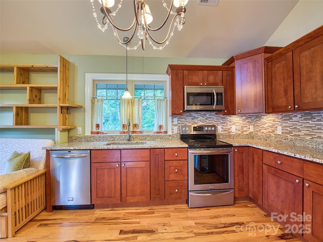 20A Lila Ln, Clyde, NC 28721 - kitchen featuring stainless steel appliances, a sink, light wood-type flooring, and a chandelier