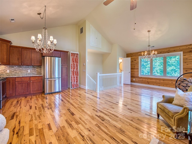 20A Lila Ln, Clyde, NC 28721 - kitchen with appliances with stainless steel finishes, a chandelier, high vaulted ceiling, light wood-style flooring, and tasteful backsplash