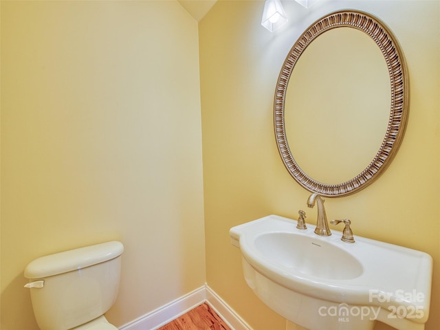 20A Lila Ln, Clyde, NC 28721 - bathroom with wood finished floors, baseboards, toilet, and a sink