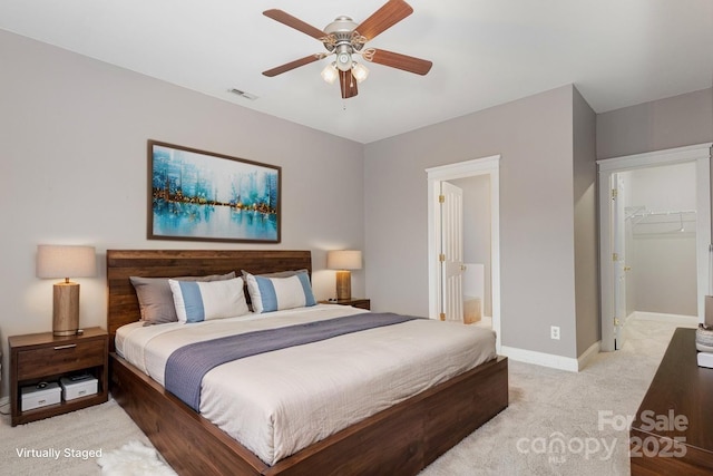 3906 Balsam St, Indian Trail, NC 28079 - bedroom featuring light carpet, baseboards, ceiling fan, connected bathroom, and a walk in closet