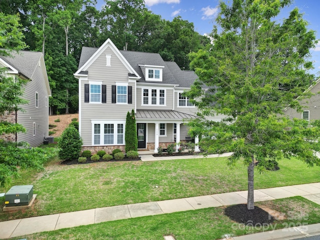 11216 Preservation Ln, Charlotte, NC 28278 - view of front of home with a porch, a front yard, a standing seam roof, a metal roof, and stone siding