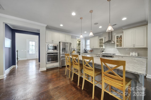 11216 Preservation Ln, Charlotte, NC 28278 - kitchen with appliances with stainless steel finishes, wall chimney range hood, ornamental molding, white cabinetry, and a center island