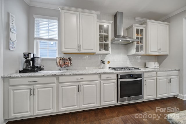 11216 Preservation Ln, Charlotte, NC 28278 - kitchen with appliances with stainless steel finishes, wall chimney exhaust hood, white cabinetry, decorative backsplash, and glass insert cabinets