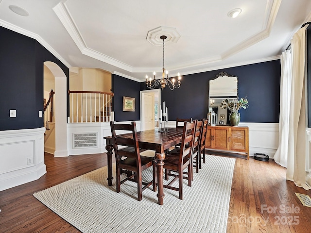 18419 Dembridge Dr, Davidson, NC 28036 - dining area with a chandelier, a wainscoted wall, a tray ceiling, crown molding, and stairway