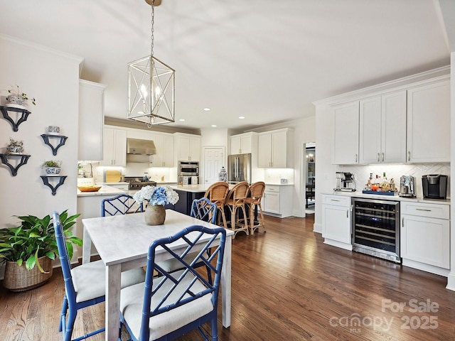 18419 Dembridge Dr, Davidson, NC 28036 - dining room featuring wine cooler, a chandelier, dark wood finished floors, bar, and recessed lighting