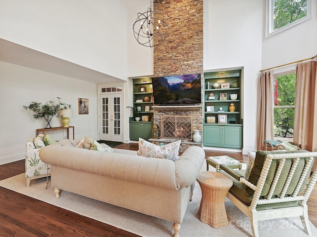 18419 Dembridge Dr, Davidson, NC 28036 - living area featuring a high ceiling, wood finished floors, baseboards, a fireplace, and french doors