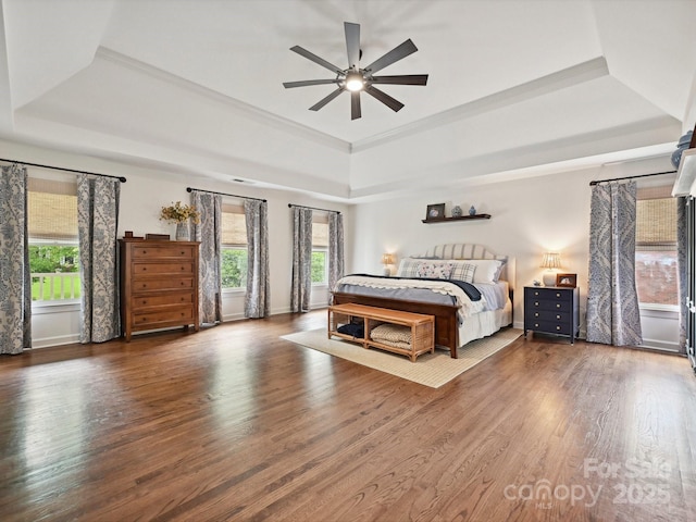 18419 Dembridge Dr, Davidson, NC 28036 - bedroom featuring a raised ceiling, multiple windows, wood finished floors, and baseboards