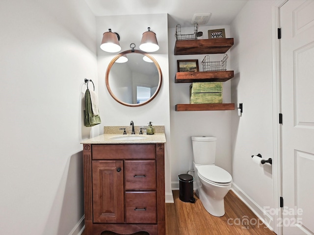 18419 Dembridge Dr, Davidson, NC 28036 - bathroom with wood finished floors, toilet, vanity, and baseboards