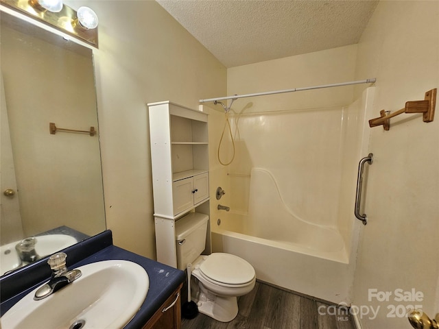 130 Susan Rd Unit 2, Casar, NC 28020 - bathroom featuring a textured ceiling, wood finished floors, toilet, vanity, and shower / tub combination