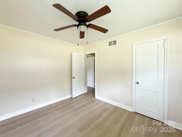 2469 Elkwood Cir, Charlotte, NC 28205 - unfurnished bedroom with light wood finished floors, baseboards, crown molding, and a ceiling fan
