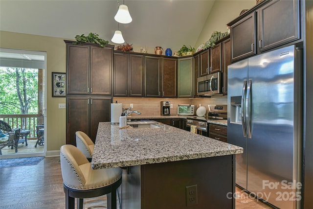 140 Atlantic Falls Trl, Black Mountain, NC 28711 - kitchen with appliances with stainless steel finishes, a sink, dark brown cabinetry, light stone countertops, and a breakfast bar area