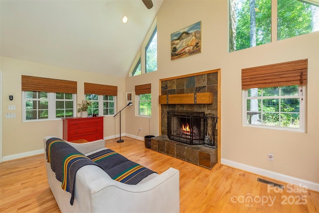 7 Western View St, Black Mountain, NC 28711 - living room with high vaulted ceiling, baseboards, wood finished floors, and a warm lit fireplace