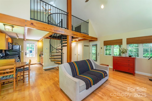 7 Western View St, Black Mountain, NC 28711 - living room featuring high vaulted ceiling, stairway, light wood-style floors, and baseboards