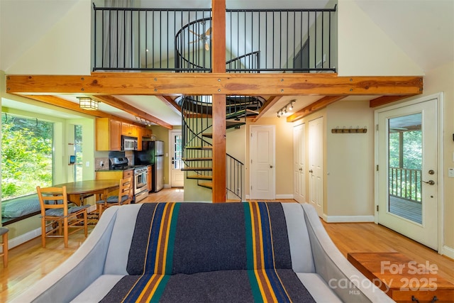 7 Western View St, Black Mountain, NC 28711 - sunken living room with light wood finished floors, baseboards, stairway, and a towering ceiling