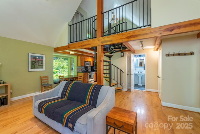 7 Western View St, Black Mountain, NC 28711 - living area with stairway, high vaulted ceiling, baseboards, and light wood-style floors