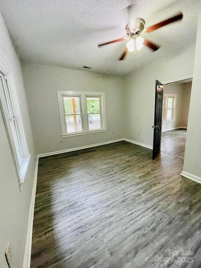 357 Huger St, Cheraw, SC 29520 - unfurnished living room with a textured ceiling, ceiling fan, dark wood finished floors, and baseboards