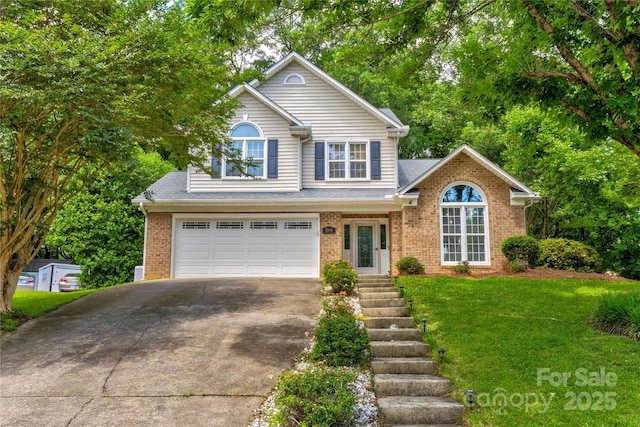 traditional home featuring driveway, an attached garage, brick siding, and a front lawn