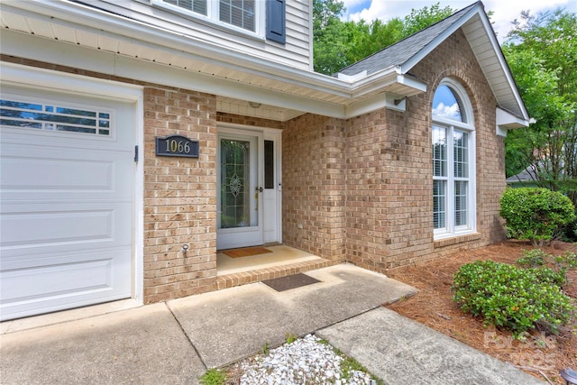 view of exterior entry with brick siding