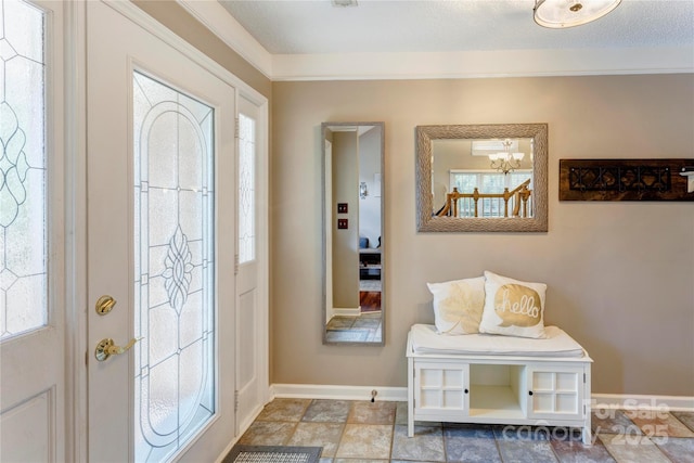 entrance foyer featuring a chandelier, baseboards, and healthy amount of natural light
