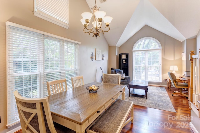 dining space with a chandelier, vaulted ceiling, and dark wood finished floors
