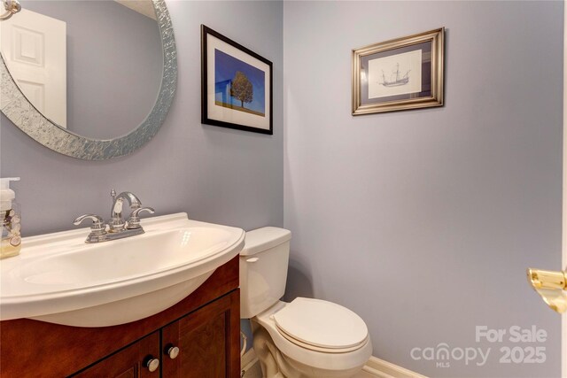 bathroom featuring toilet and vanity