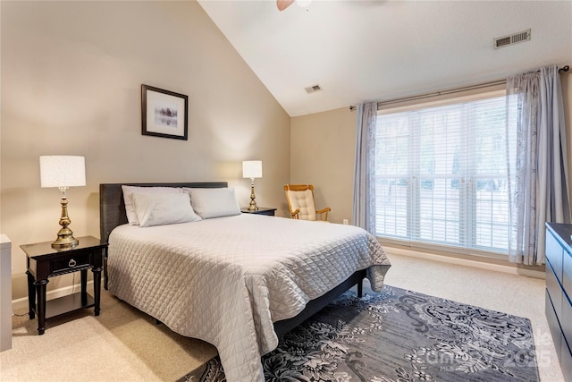 bedroom with light carpet, lofted ceiling, baseboards, and a ceiling fan