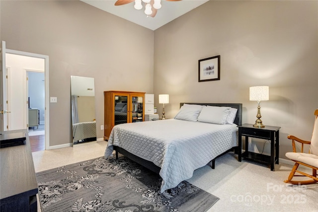 bedroom featuring high vaulted ceiling, light colored carpet, baseboards, and a ceiling fan