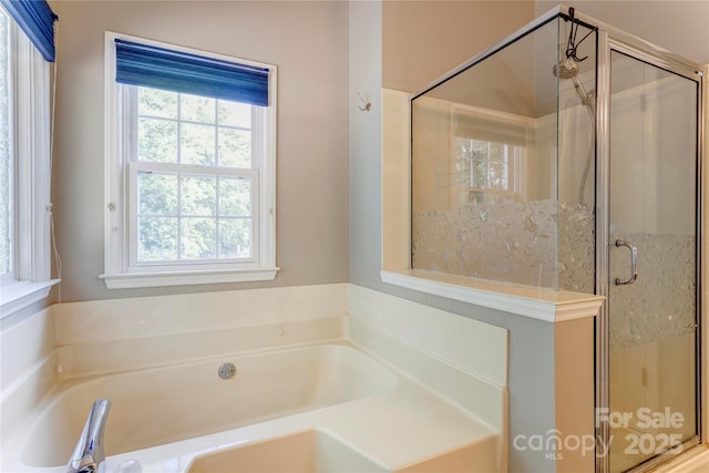 bathroom with a garden tub and a stall shower