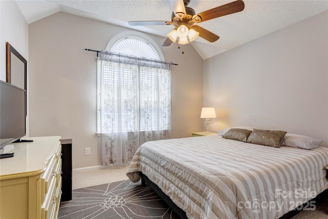 bedroom with lofted ceiling, dark carpet, a ceiling fan, and baseboards
