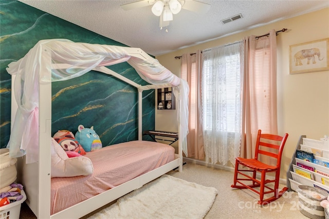 carpeted bedroom featuring a textured ceiling and ceiling fan