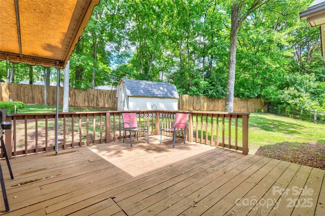wooden deck with a storage shed and an outdoor structure
