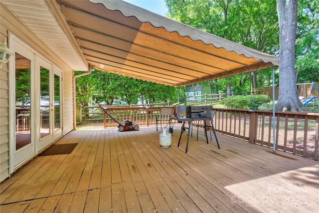 wooden terrace with outdoor dining space and fence