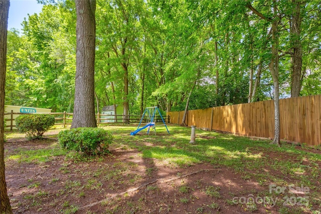 fenced backyard featuring a playground