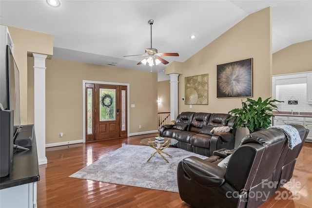 1825 Smyre Farm Rd, Newton, NC 28658 - living room with decorative columns, vaulted ceiling, ceiling fan, wood finished floors, and baseboards