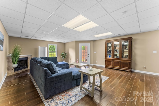 1825 Smyre Farm Rd, Newton, NC 28658 - living area with dark wood-type flooring, baseboards, and a paneled ceiling