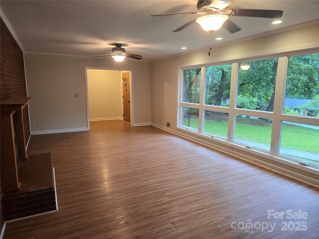 520 Crestview Dr, Albemarle, NC 28001 - unfurnished living room featuring a ceiling fan, plenty of natural light, ornamental molding, baseboards, and a textured ceiling