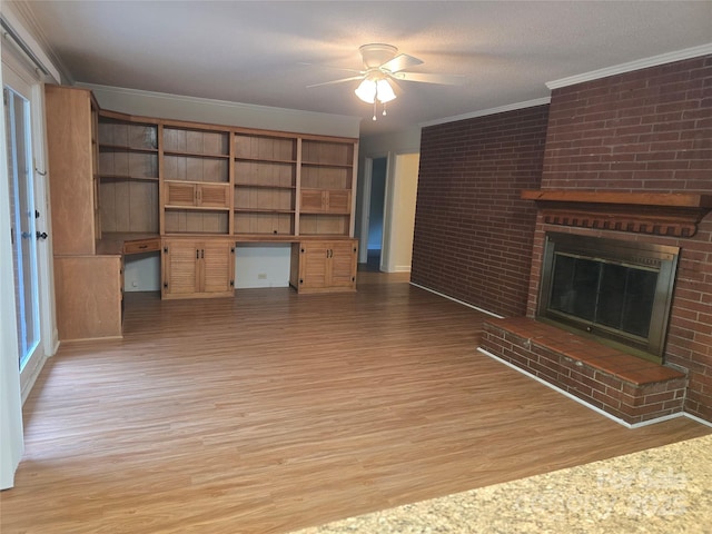 520 Crestview Dr, Albemarle, NC 28001 - unfurnished living room with light wood-style flooring, crown molding, a ceiling fan, a fireplace, and brick wall