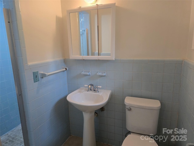 520 Crestview Dr, Albemarle, NC 28001 - bathroom with a wainscoted wall, toilet, tile walls, and a shower stall