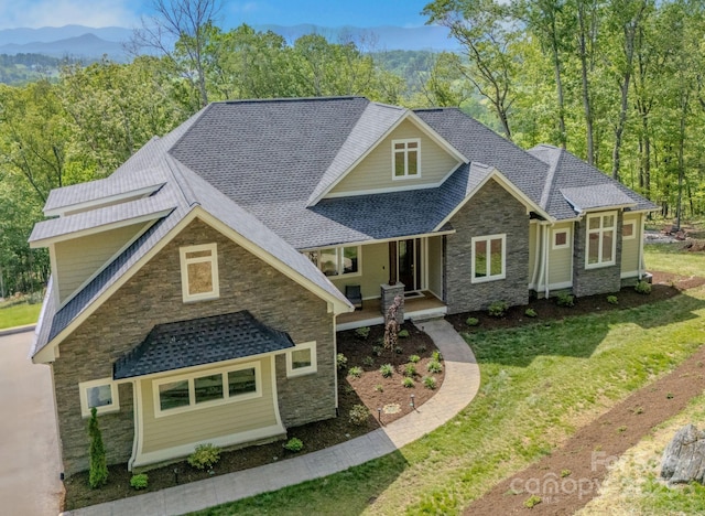 128 Saddle Ridge Dr, Alexander, NC 28701 - craftsman inspired home with stone siding, a front yard, roof with shingles, a mountain view, and a porch