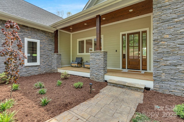 128 Saddle Ridge Dr, Alexander, NC 28701 - view of exterior entry with covered porch and stone siding