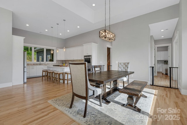 128 Saddle Ridge Dr, Alexander, NC 28701 - dining room featuring light wood-style floors, recessed lighting, and a high ceiling